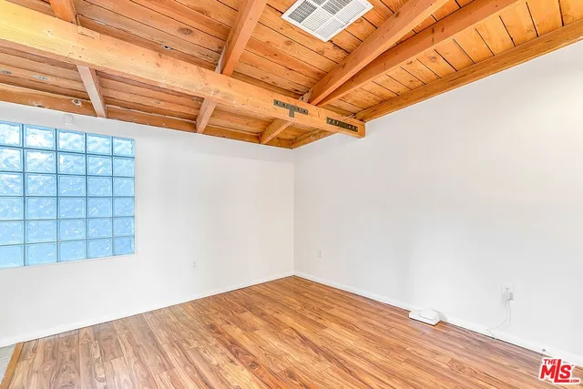 a view of a room with wooden floor