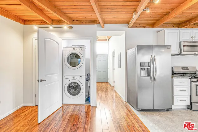 a view of a kitchen with refrigerator and washer