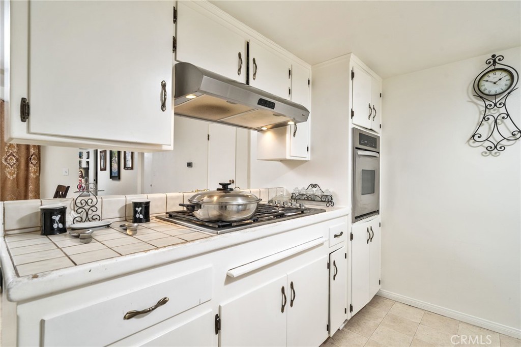 5035 Carlingford Avenue Riverside, CA 92504 - Photo 12 of 32 a kitchen with stainless steel appliances a sink and a white cabinets