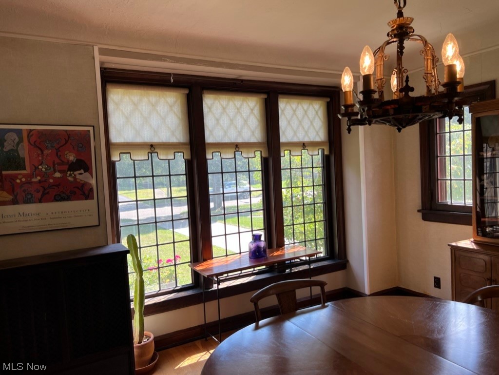 2572 Eaton Road Cleveland, OH 44118 - Photo 10 of 35 Wood floored dining area Chandelier and a wealth of natural light