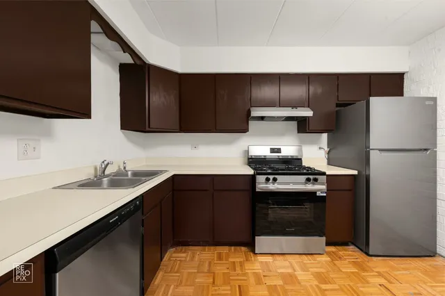 a kitchen with a sink and a refrigerator