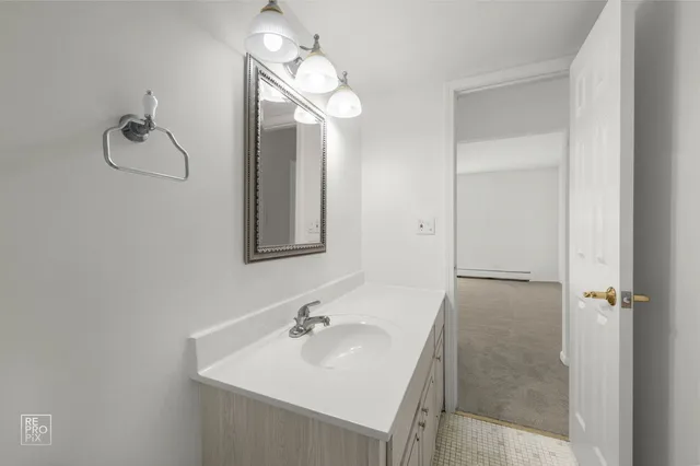 a bathroom with a sink a mirror and shower