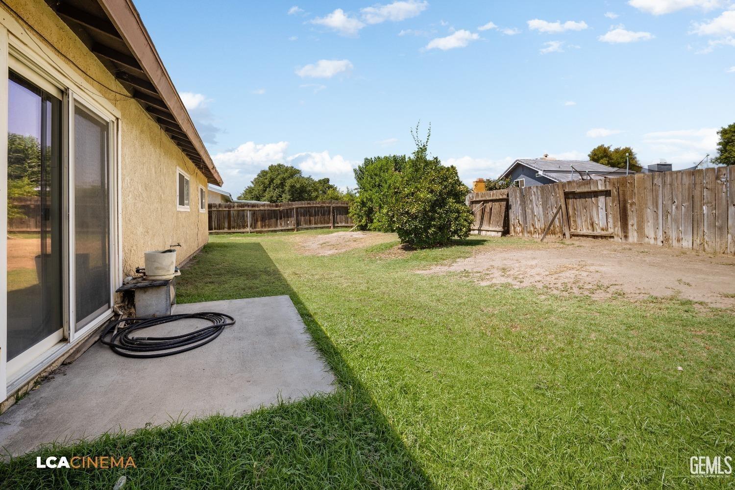 Undisclosed Address Bakersfield, CA 93304 - Photo 14 of 15 a view of a backyard with plants and a patio