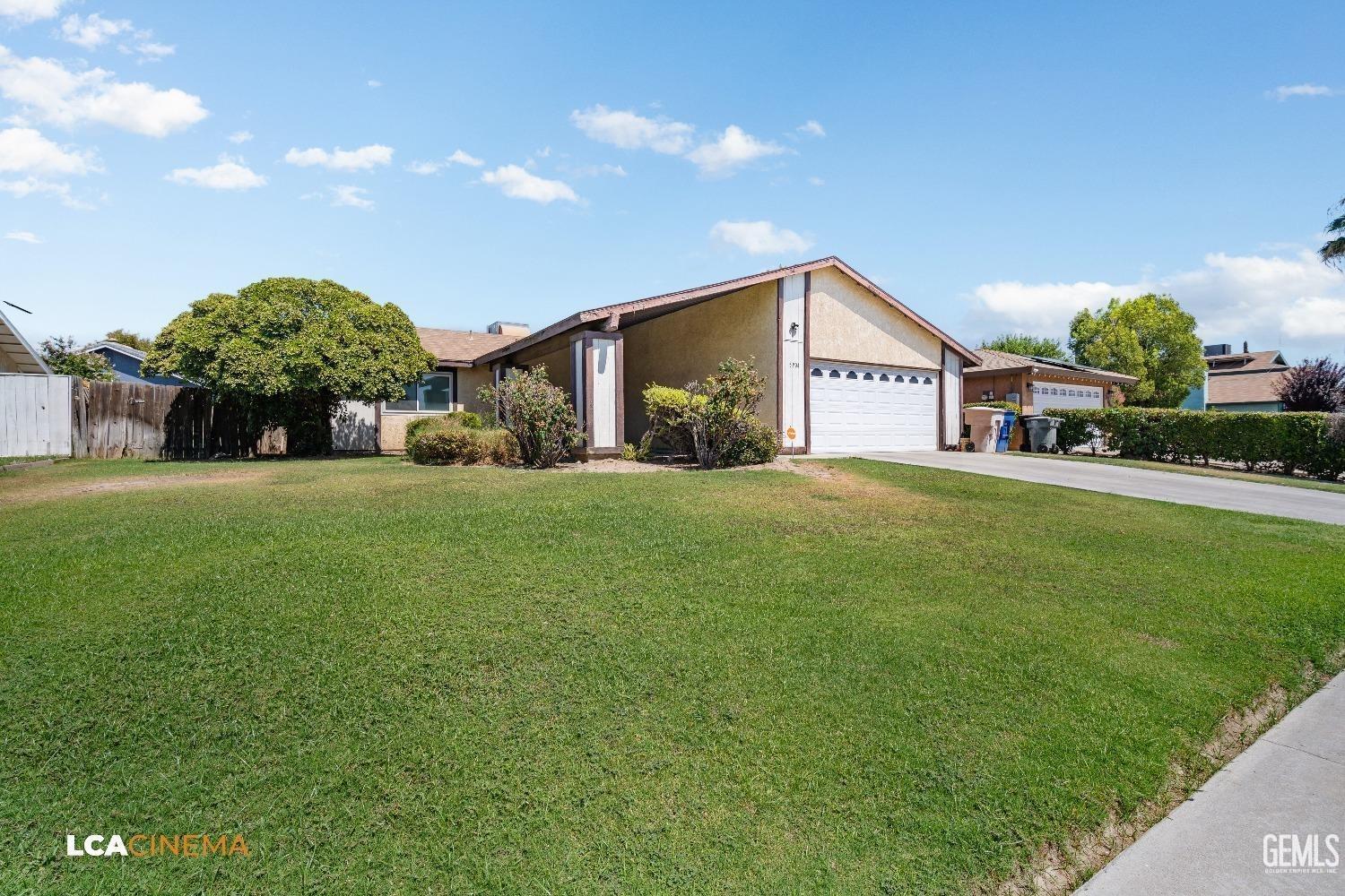 Undisclosed Address Bakersfield, CA 93304 - Photo 2 of 15 a view of a house with a big yard and large trees