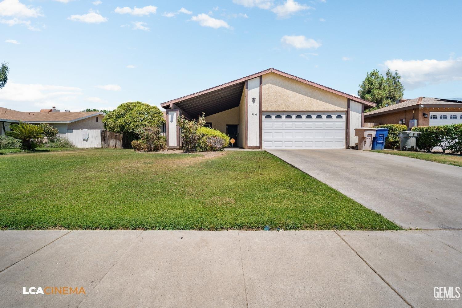 Undisclosed Address Bakersfield, CA 93304 - Photo 3 of 15 a view of an house with backyard space and a garage