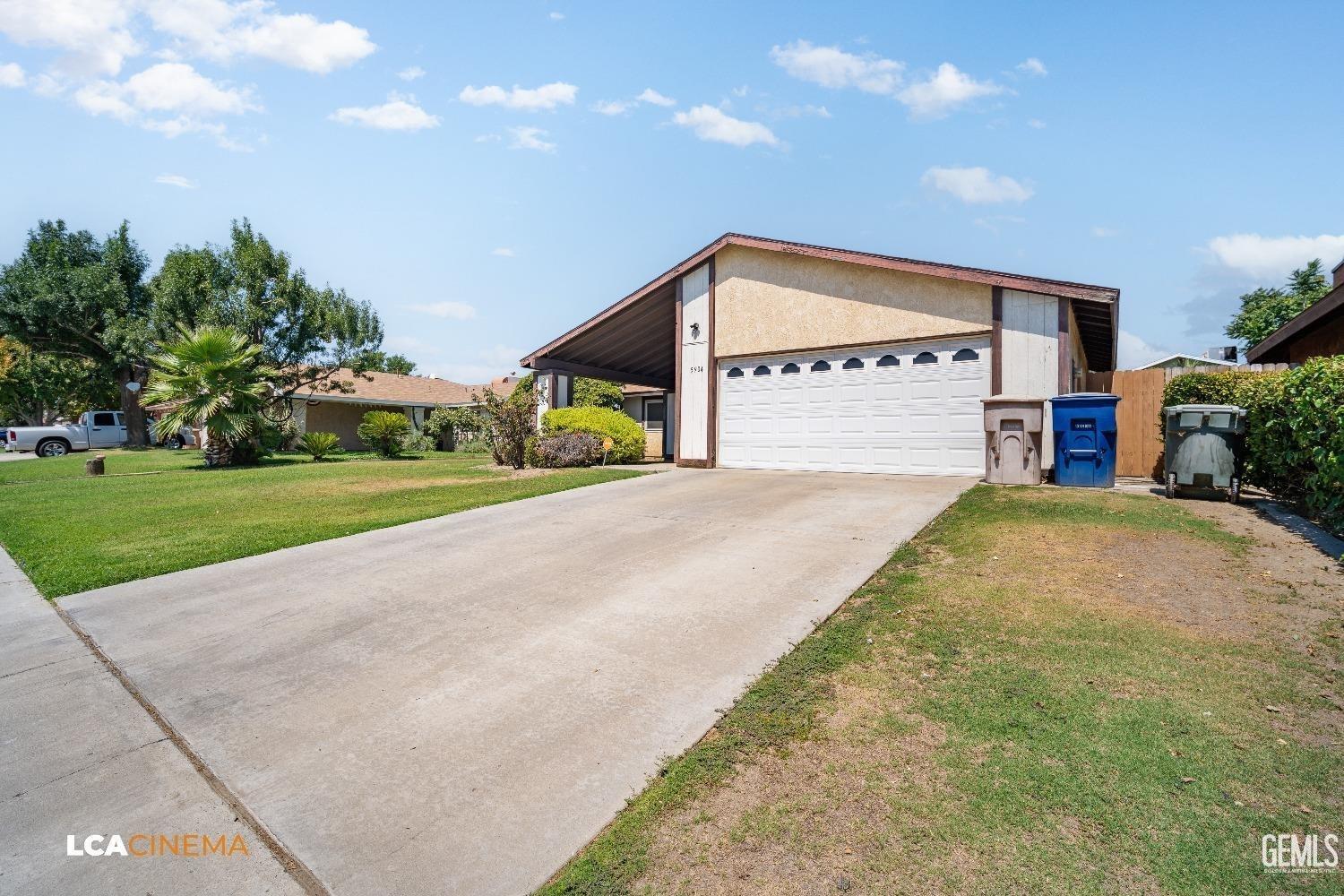 Undisclosed Address Bakersfield, CA 93304 - Photo 4 of 15 a view of a house with a yard and garage
