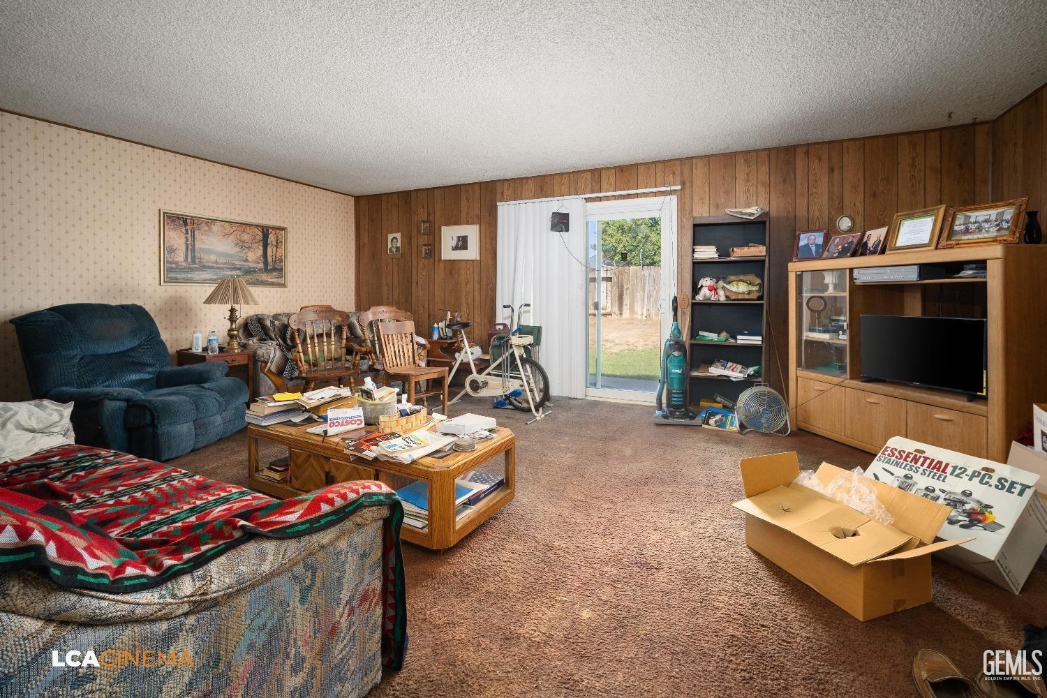 Undisclosed Address Bakersfield, CA 93304 - Photo 5 of 15 a living room with furniture a flat screen tv and a window