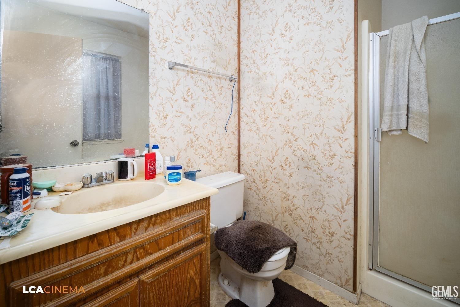 Undisclosed Address Bakersfield, CA 93304 - Photo 8 of 15 a bathroom with a sink toilet and shower