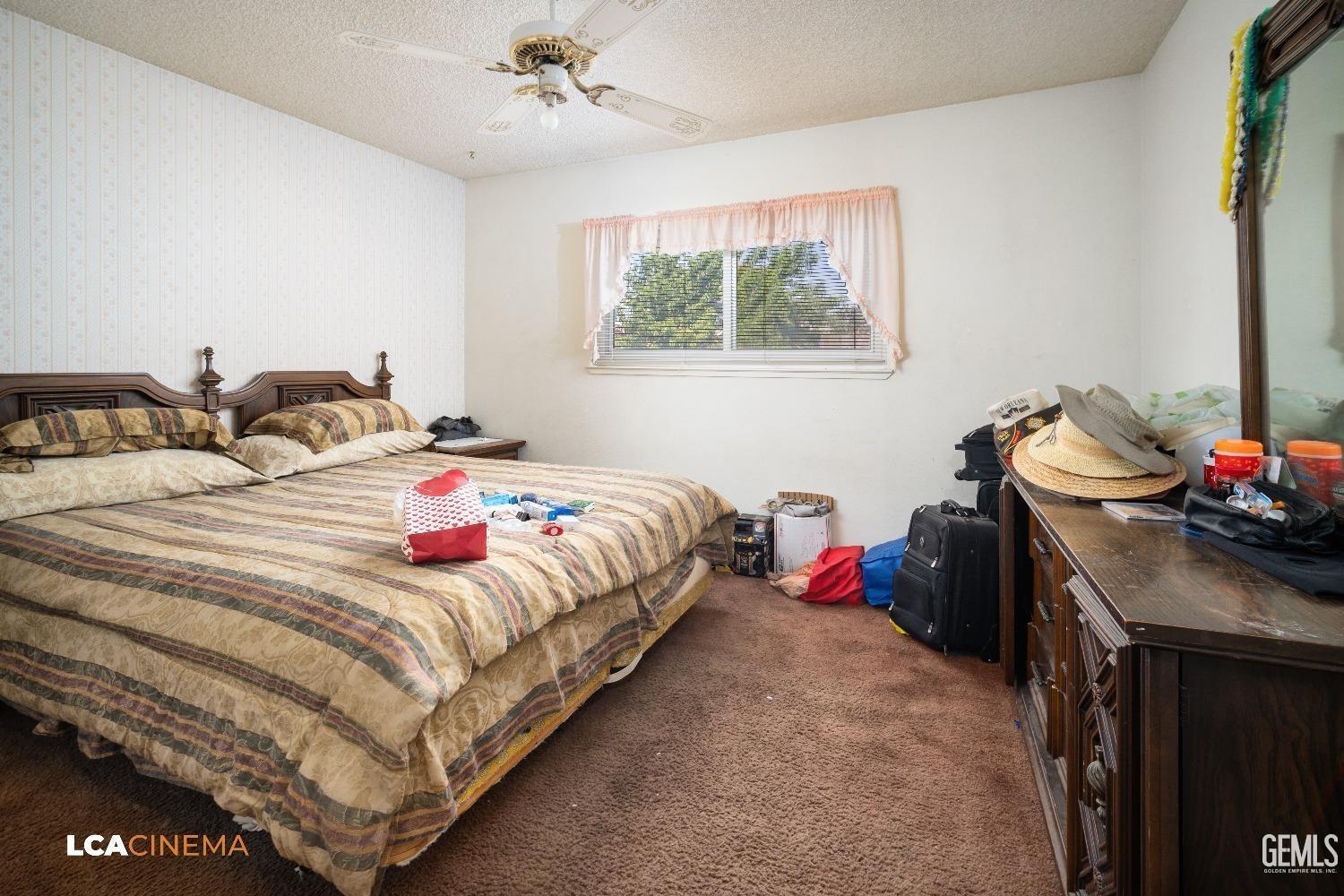 Undisclosed Address Bakersfield, CA 93304 - Photo 9 of 15 a bedroom with a bed and a window