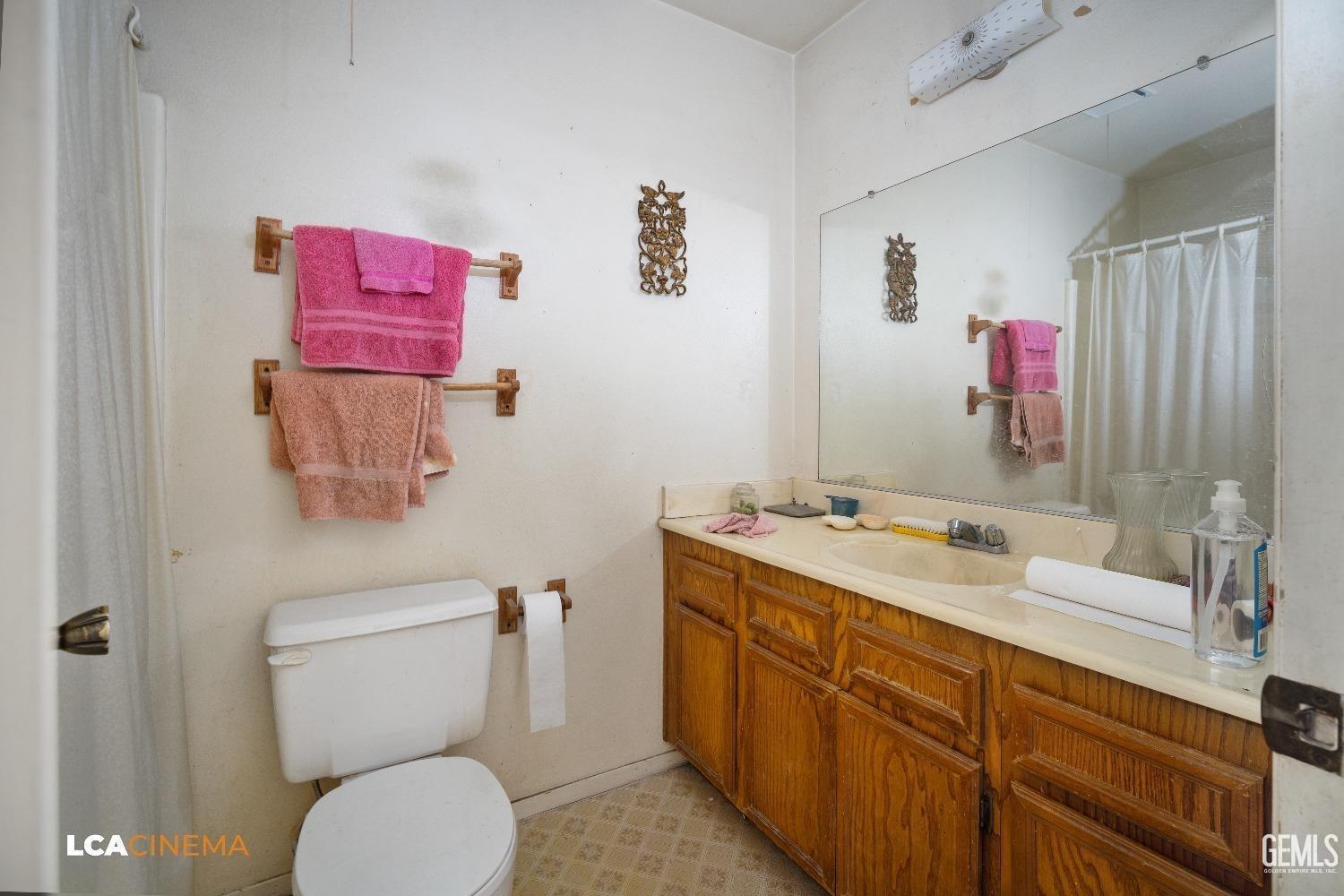 Undisclosed Address Bakersfield, CA 93304 - Photo 10 of 15 a bathroom with a sink mirror vanity and toilet
