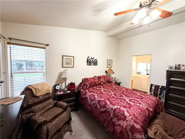 a bedroom with bed and window