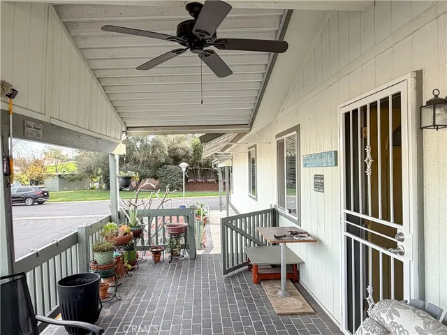 a view of a porch with furniture and a yard