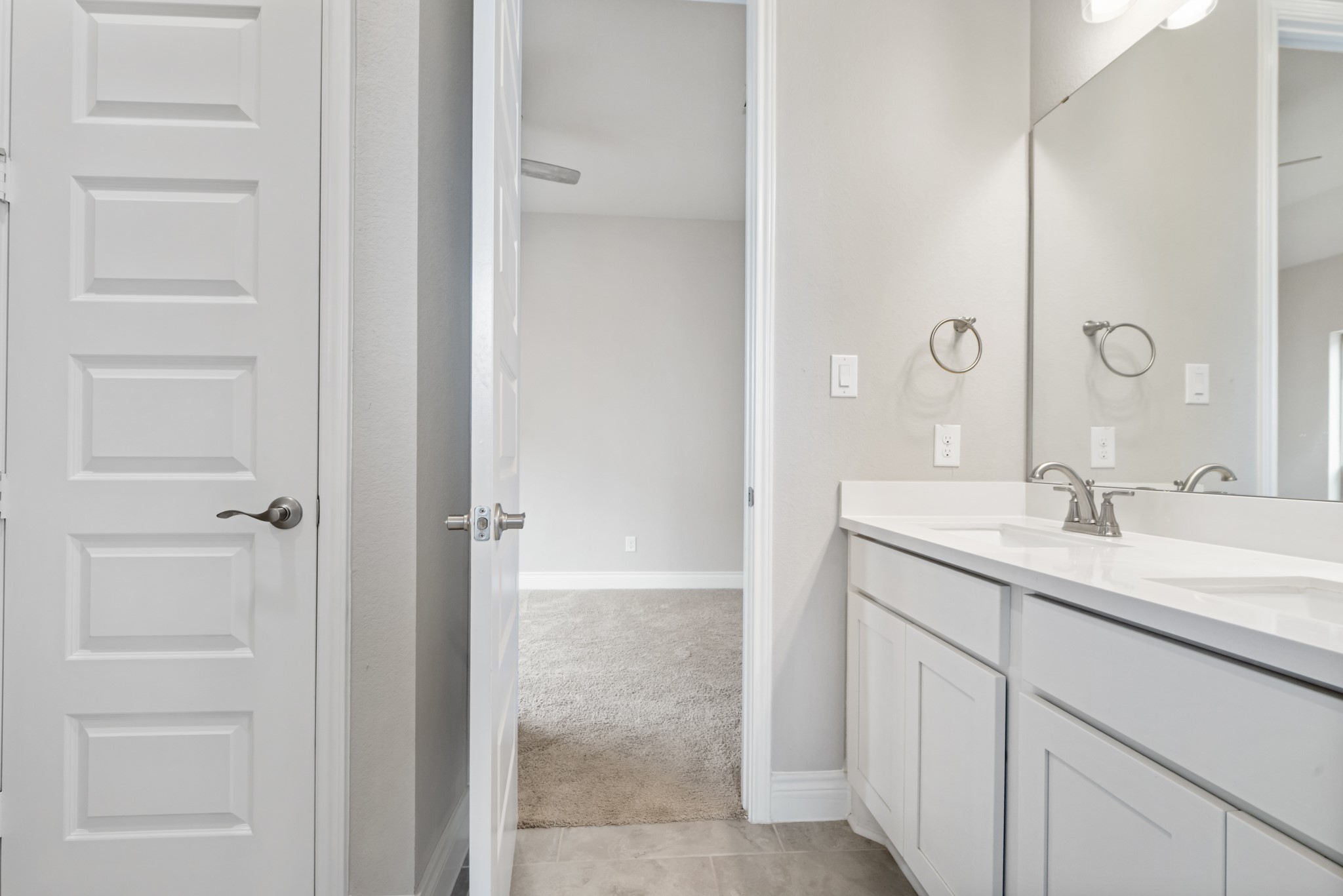 104 Catani Loop Georgetown, TX 78628 - Photo 18 of 34 This bathroom features a double vanity with white cabinetry and a light-colored countertop