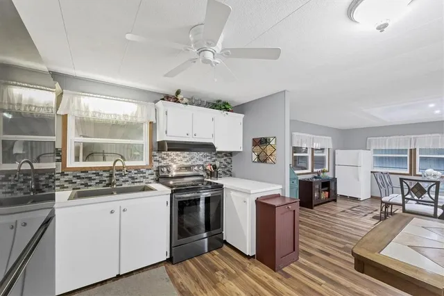 a kitchen with a stove sink and cabinets