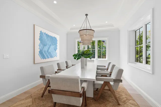 a dining room with furniture a chandelier and window