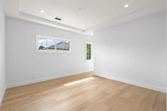 a view of room with window and painting on the wall