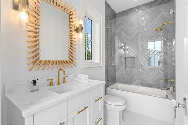 a bathroom with a sink toilet and shower