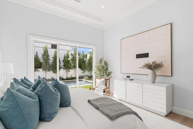 a living room with furniture large windows and a flat screen tv