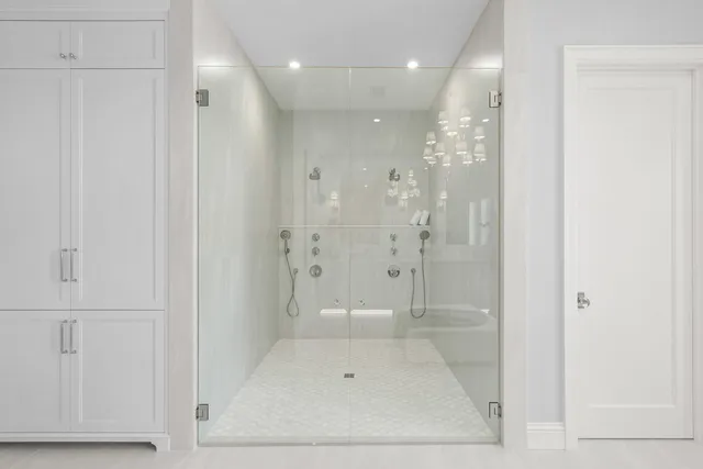 a bathroom with a glass shower door