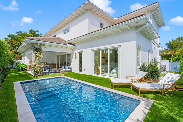 a view of a house with swimming pool and a yard