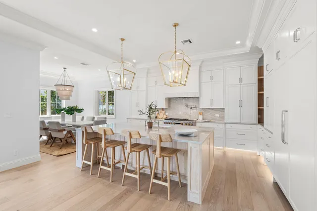 a large kitchen with a table and chairs