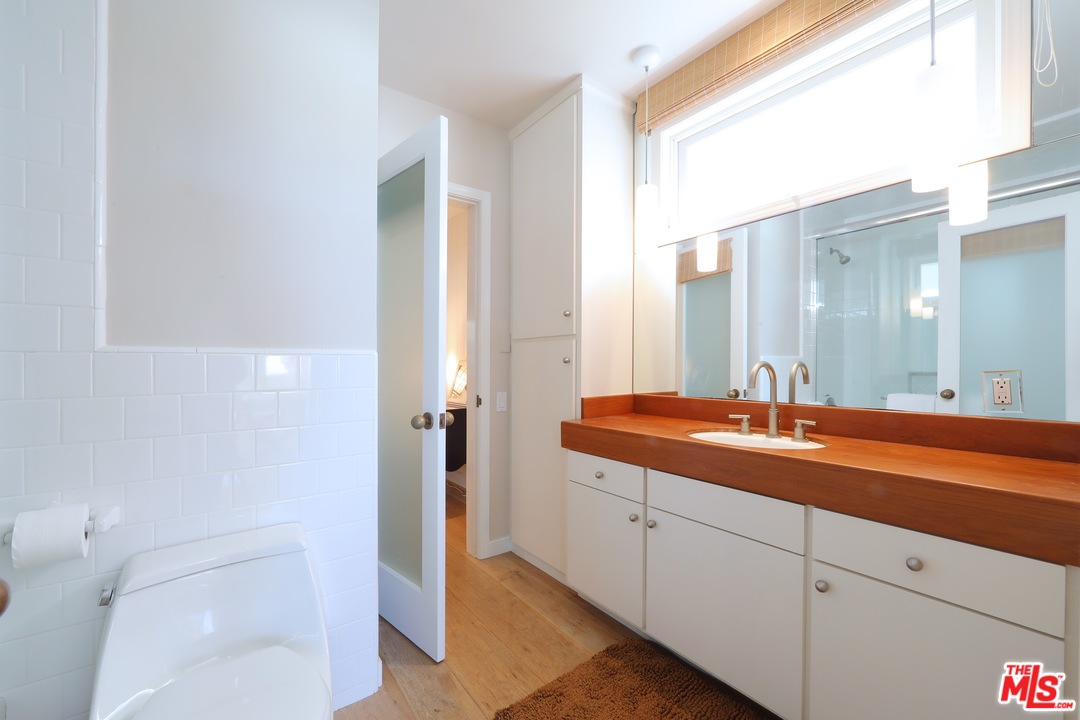 31008 Broad Beach Road Malibu, CA 90265 - Photo 25 of 40 a spacious bathroom with a granite countertop sink and a mirror