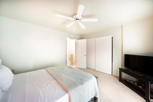 a bedroom with a bed and a flat screen tv