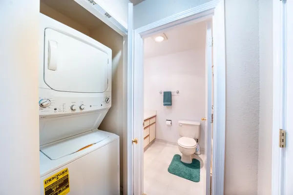 a bathroom with a toilet and a mirror