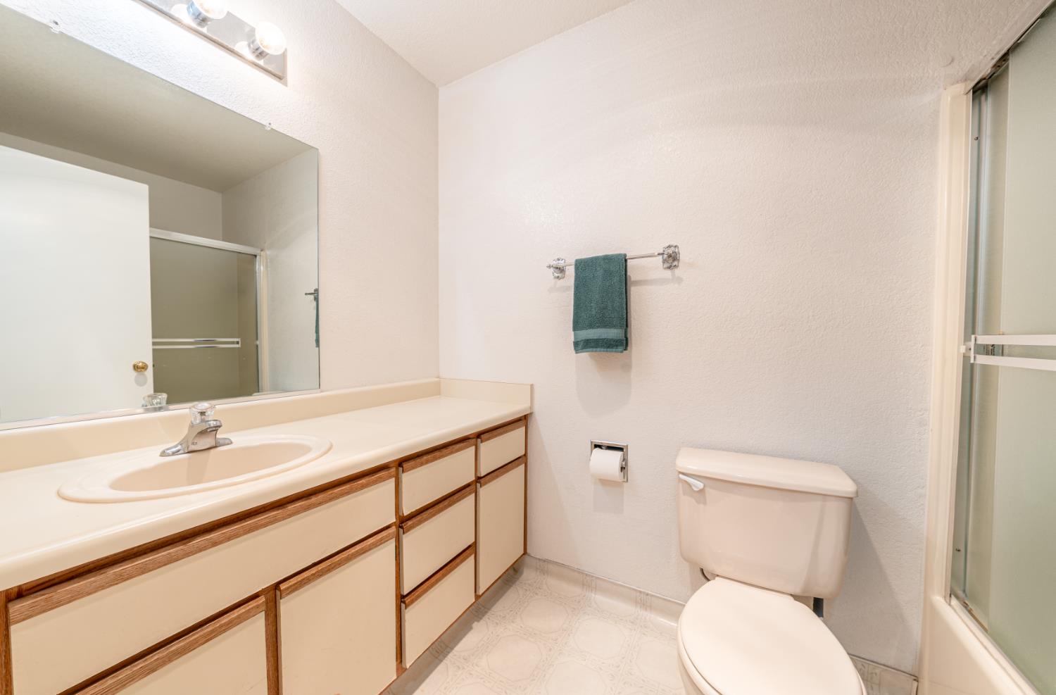 1002 Manuel Road Arnold, CA 95223 - Photo 16 of 34 a bathroom with a toilet sink and mirror