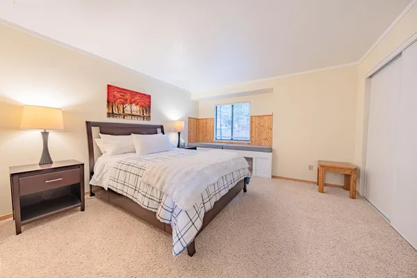 a bedroom with a bed and a night stand