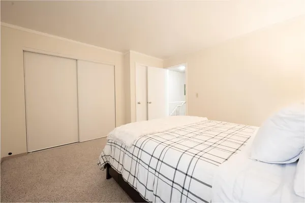 a bedroom with a bed and a closet