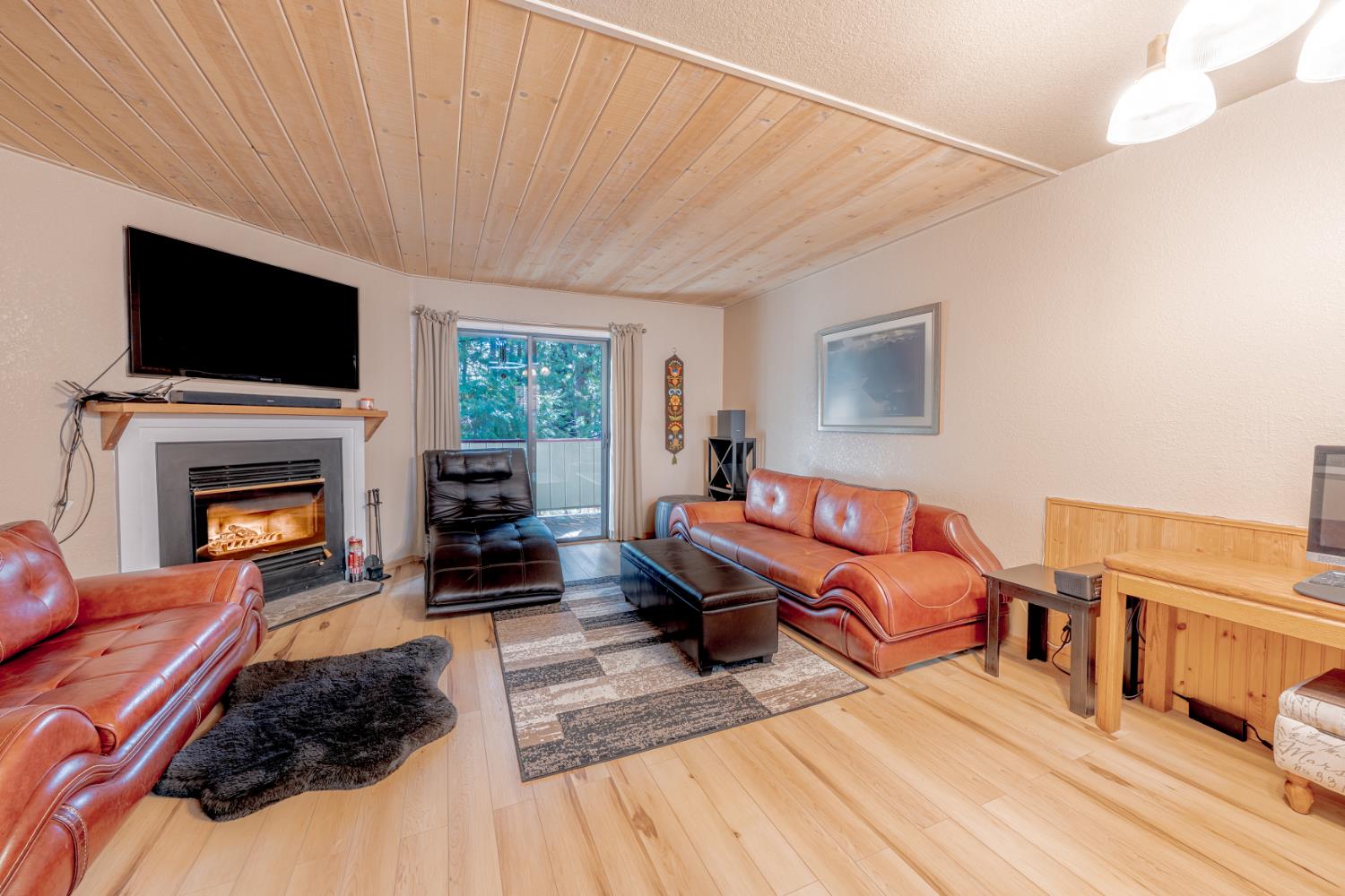 1002 Manuel Road Arnold, CA 95223 - Photo 2 of 34 a living room with furniture a flat screen tv and a fireplace