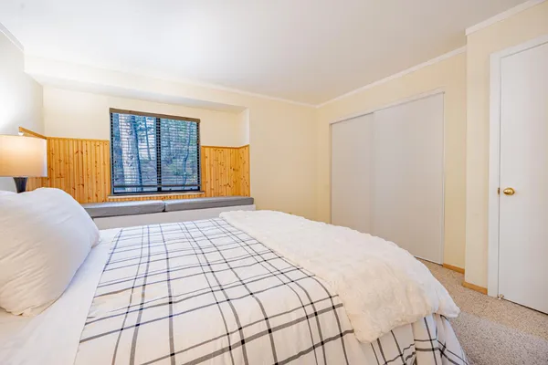 a bedroom with a bed and a window