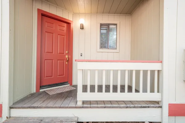 a white house with wooden floor and glass door