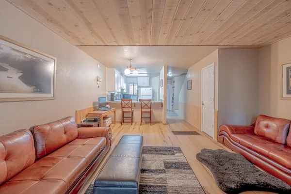 a view of a room with wooden floor and a window