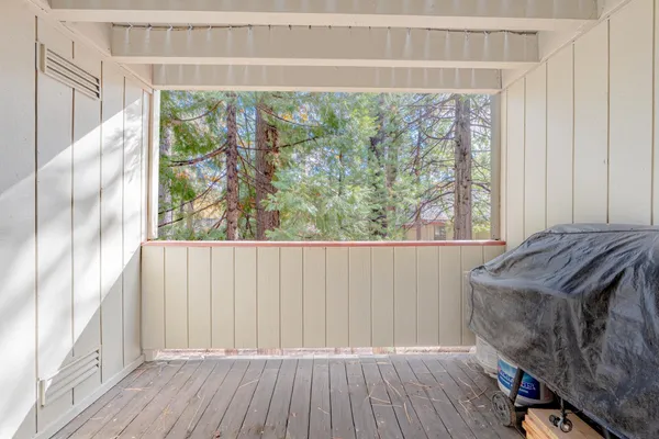 a view of a room with wooden floor and a window