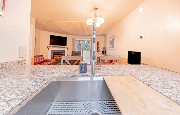 a view of a living room kitchen and a sink