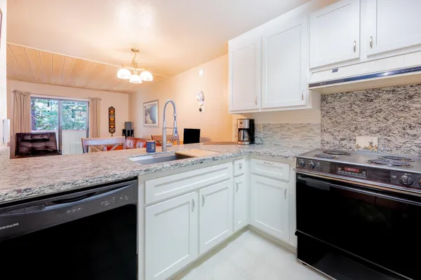 a view of a living room kitchen and a sink