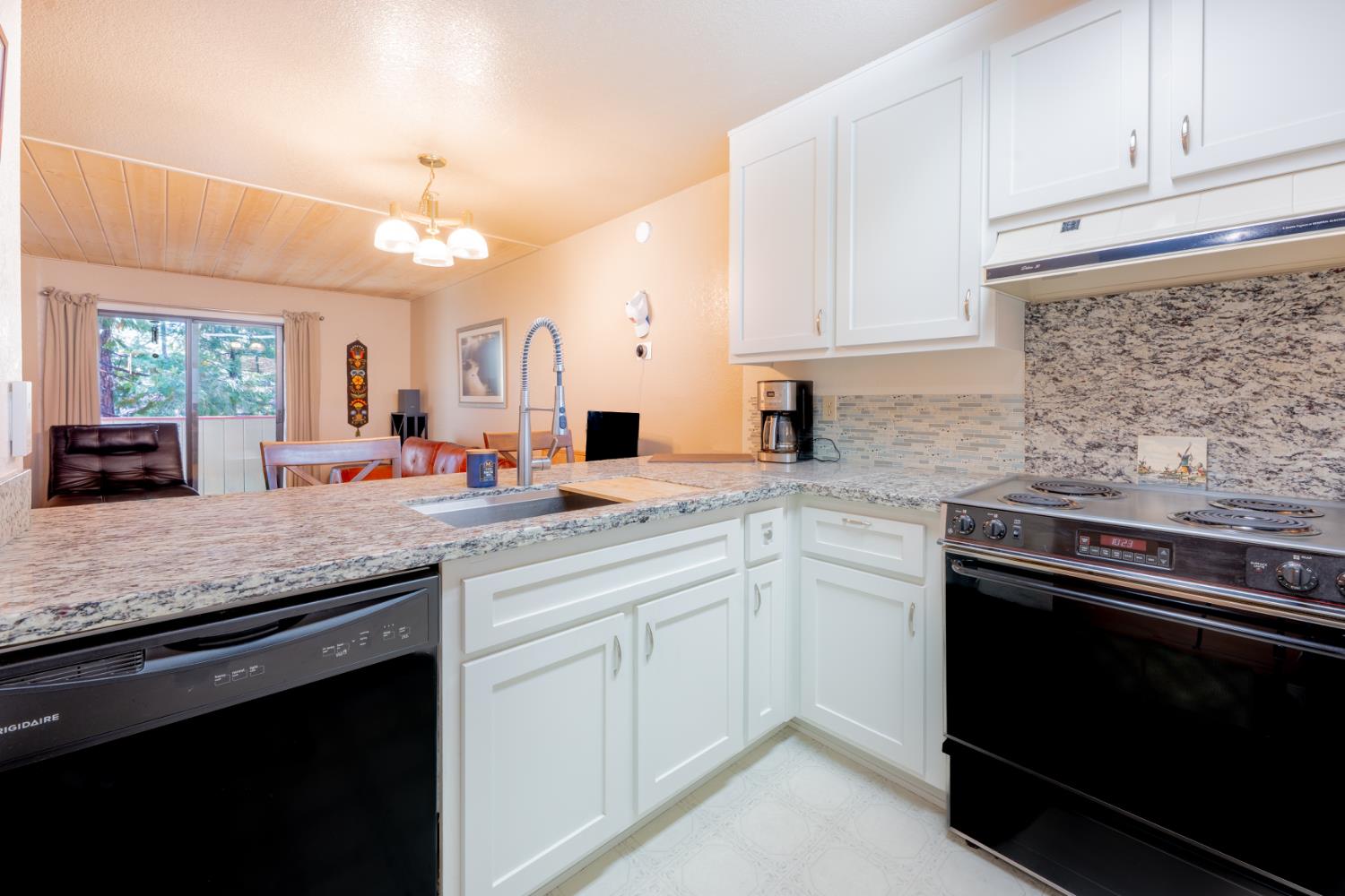 1002 Manuel Road Arnold, CA 95223 - Photo 6 of 34 a kitchen with white cabinets and appliances