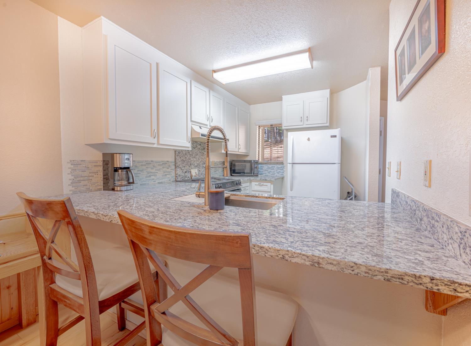1002 Manuel Road Arnold, CA 95223 - Photo 8 of 34 a kitchen with stainless steel appliances granite countertop a sink refrigerator and cabinets