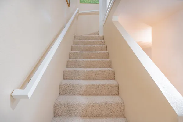 a view of staircase with white walls