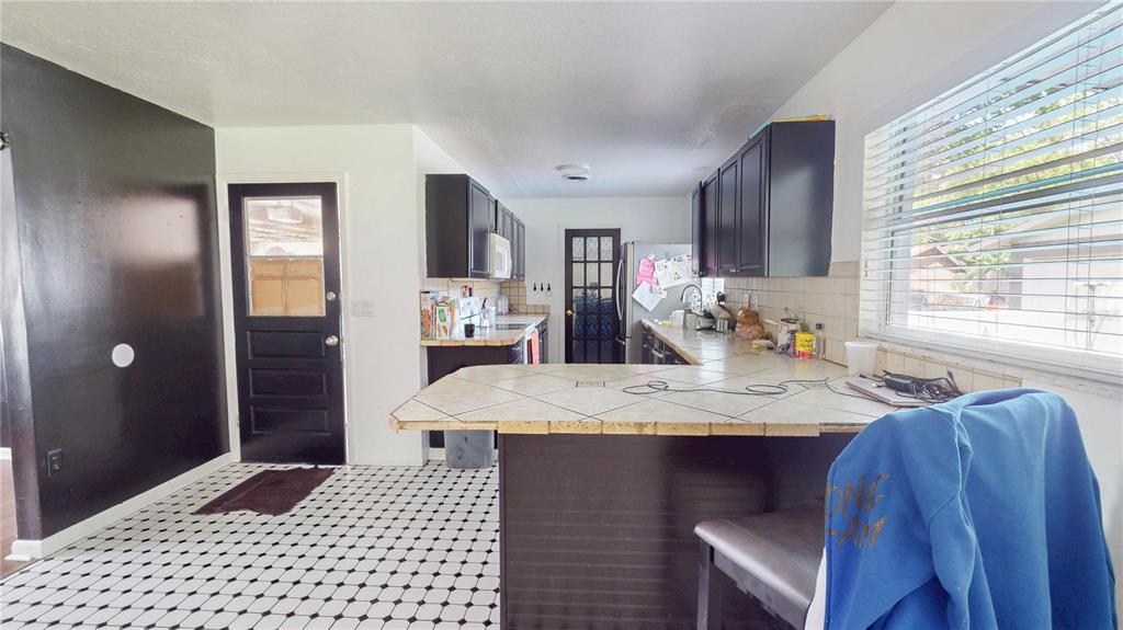 2009 Northeast 50th Street Ocala, FL 34479 - Photo 5 of 15 a bathroom with a granite countertop sink a mirror and a shower