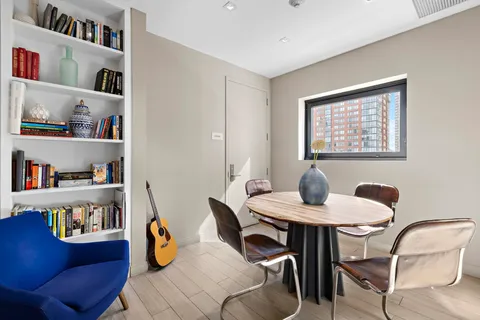 a dining room with furniture and wooden floor