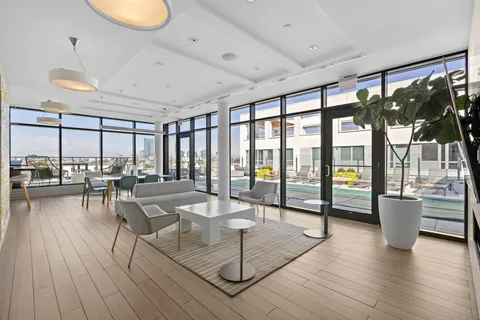 a room with lots of furniture and a large window