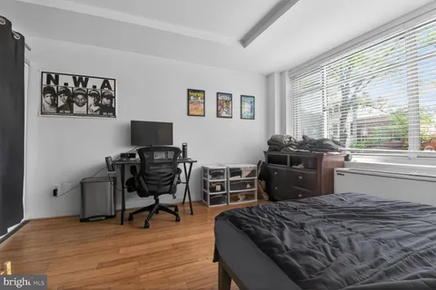 a bedroom with a bed and a desk