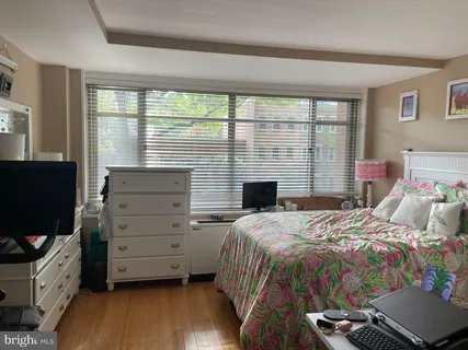 a bedroom with a bed and a flat tv screen