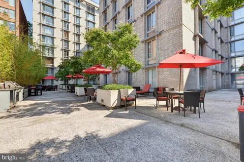 a patio with a table and chairs under an umbrella