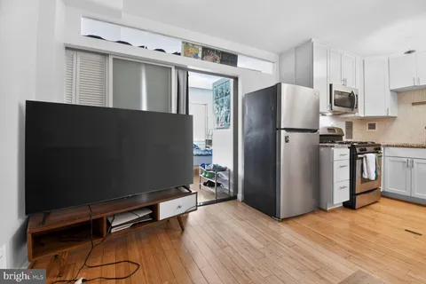 a kitchen with stainless steel appliances a refrigerator and a stove top oven