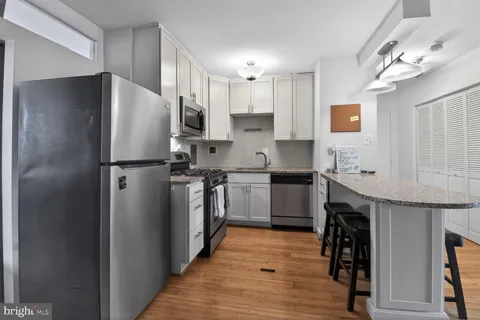 a kitchen with a refrigerator a sink and dishwasher