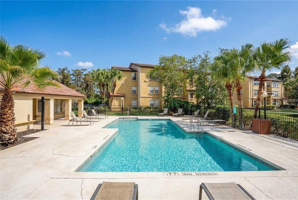 5120 Conroy Road, Unit 13 Orlando, FL 32811 - Photo 17 of 25 a view of a swimming pool with a patio